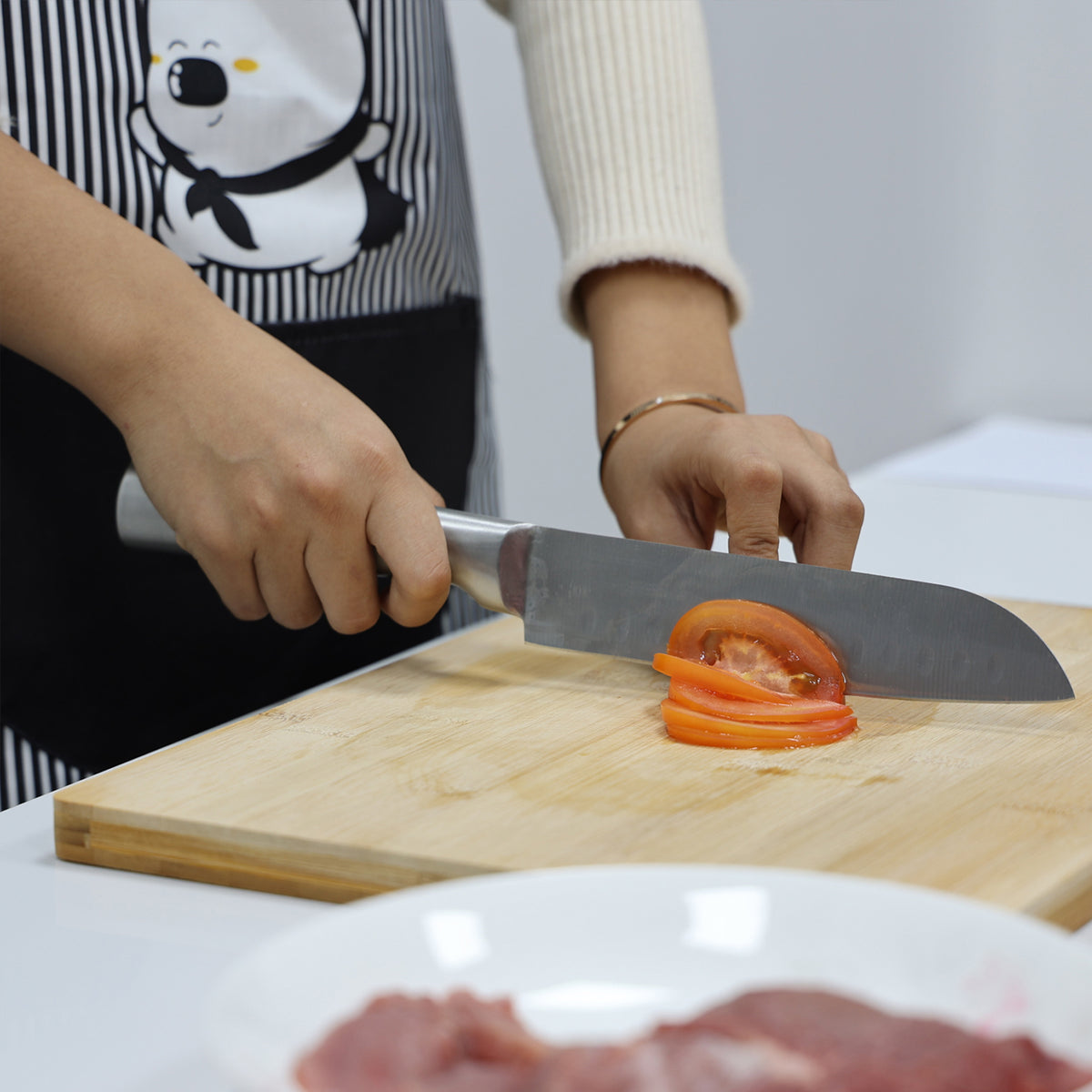 Faca Zurique cortando tomate sobre a tábua